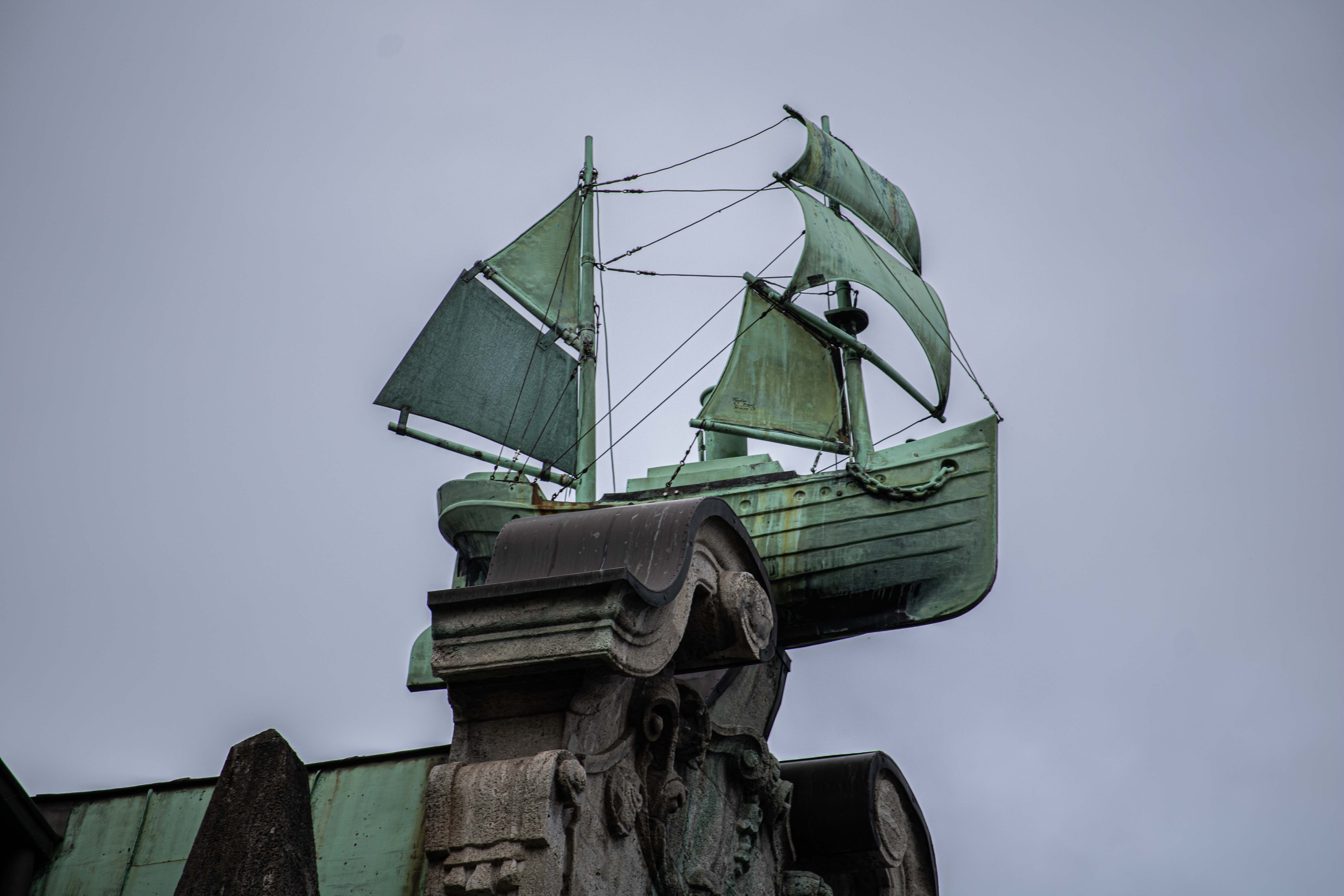 statue of a ship ontop of a pole